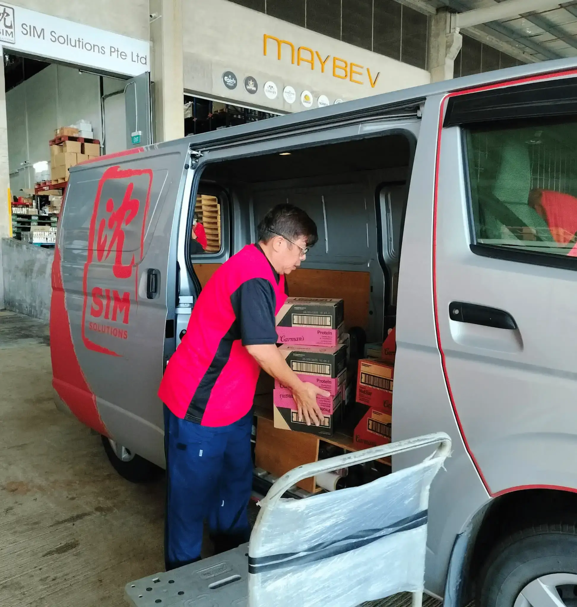staff loading items into delivery van